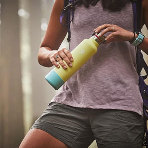 A woman holding a tumbler with a silicone water bottle/tumbler boot